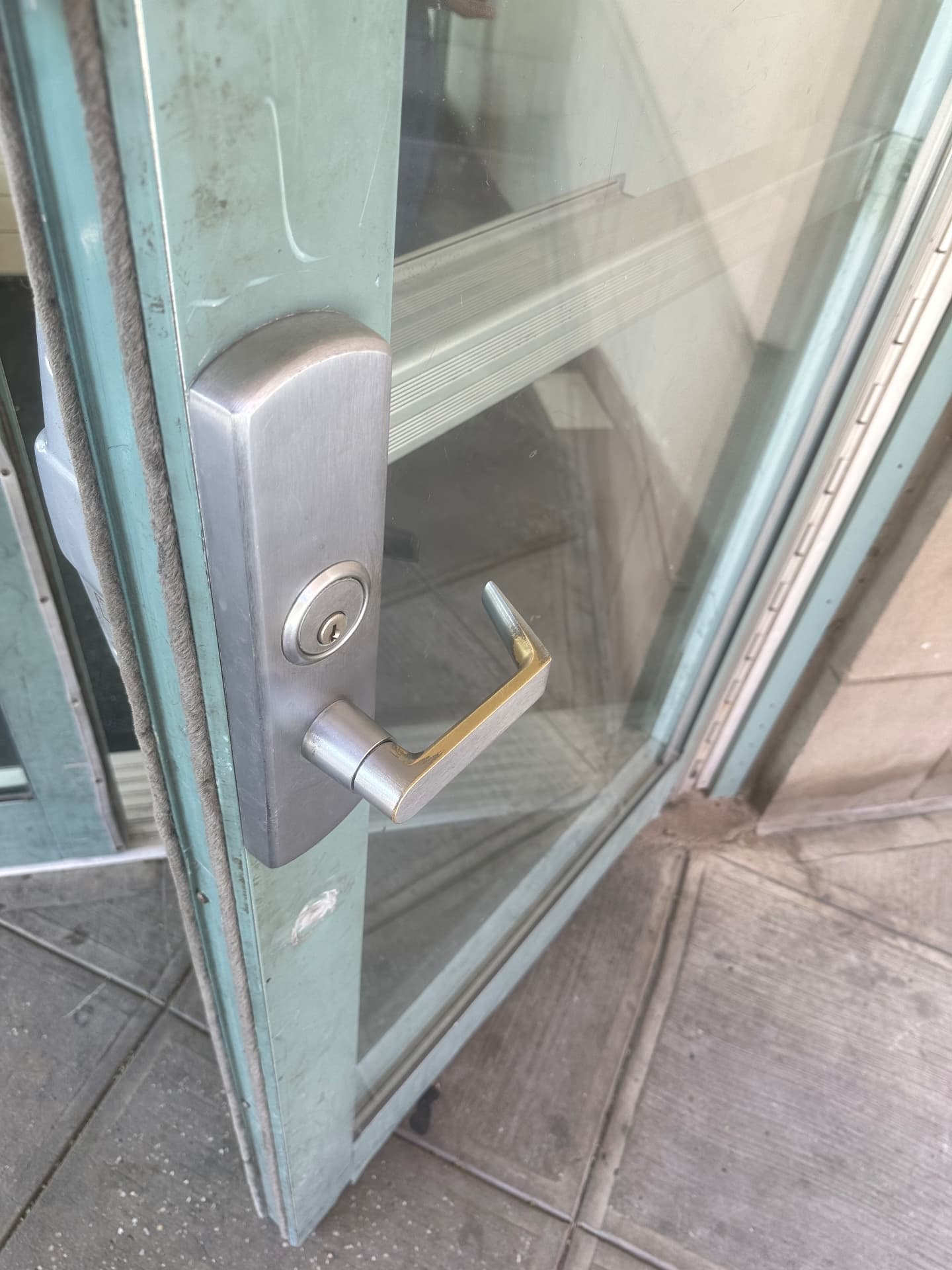 Commercial glass storefront door with new lever handle and cylinder lock