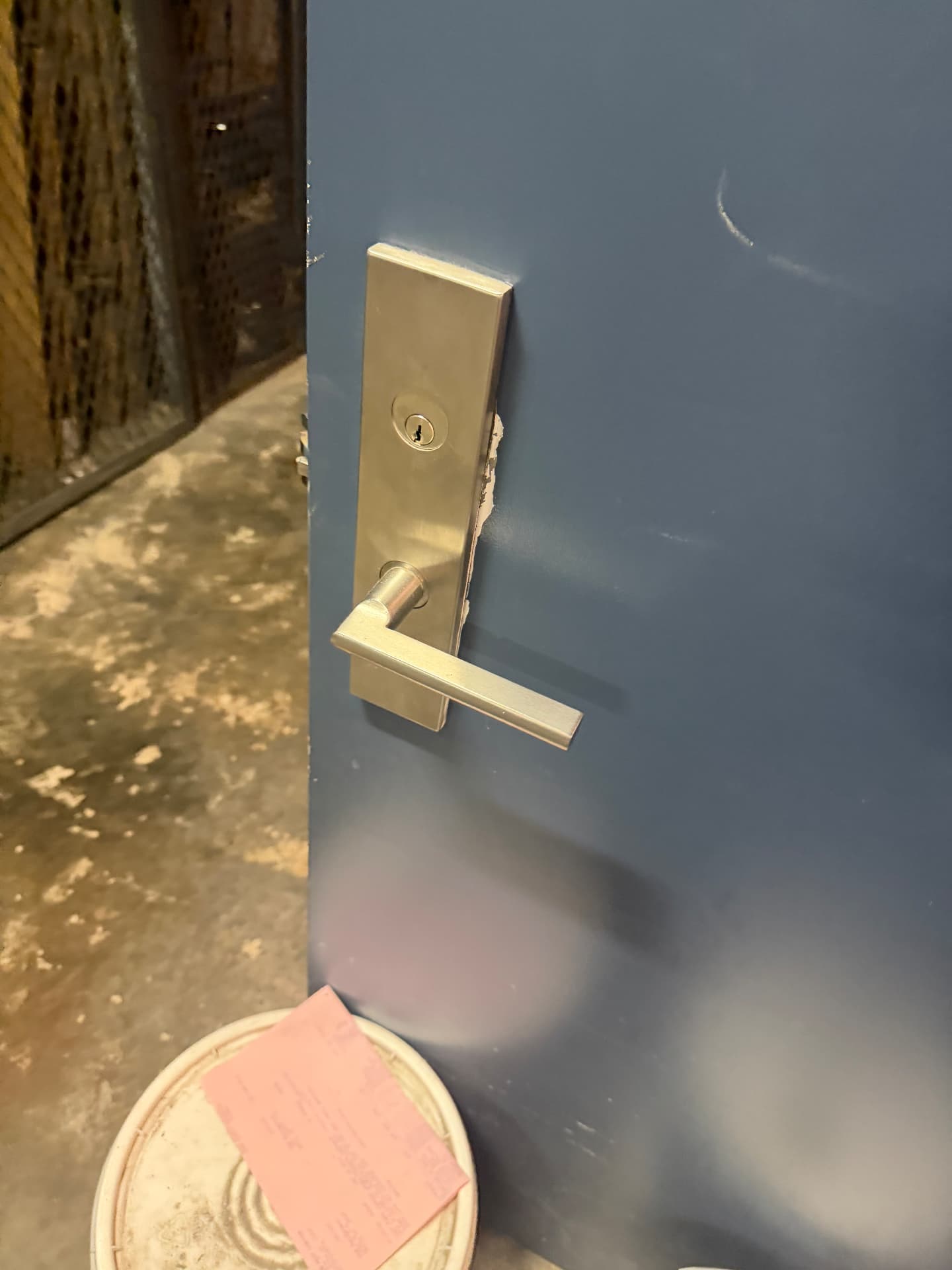 Steel commercial door with new mortise lock and lever handle installed